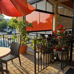 Four Brothers Restaurant & Pizza - Patio/side entrance area(not always is the door opened) of Four Brothers Restaurant.  This patio is very visible from the parking area.