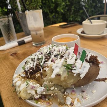 Quiero Brunch - Baked potato with added birria & my half drunk coffee - Mexican Near Me - Temecula, California Quiero Brunch - Baked potato with added birria & my half drunk coffee - Mexican Near Me - Temecula, California