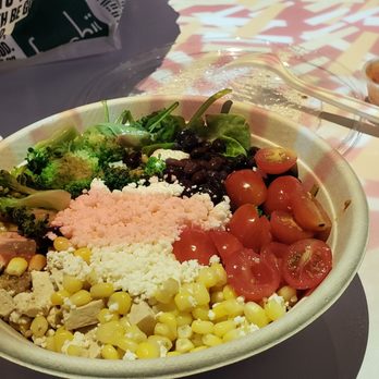 Freshii - a bowl of vegetables and rice with a spoon - Salad Near Me - Toronto, Ontario
