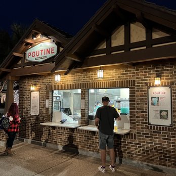 The Daily Poutine - two people standing outside of a restaurant - Poutineries Near Me - Lake Buena Vista, Florida The Daily Poutine - two people standing outside of a restaurant - Poutineries Near Me - Lake Buena Vista, Florida
