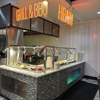 Number 1 Buffet - A buffet setup with food trays and a neon sign overhead that says 'Grill & BBQ Hibachi,' located inside a restaurant. - Buffets Near Me - Avondale, Arizona