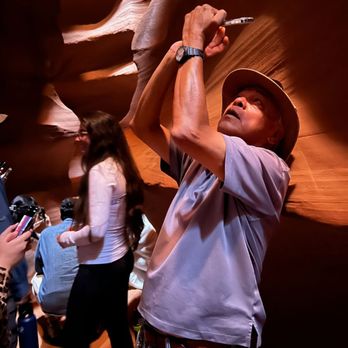Antelope Canyon Navajo Tours - Leo taking a nice picture of the canyon for someone - Walking Tours Near Me - Page, Arizona Antelope Canyon Navajo Tours - Leo taking a nice picture of the canyon for someone - Walking Tours Near Me - Page, Arizona