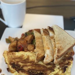 Sausage egg and cheese omelette with white toast and potatoes Sausage egg and cheese omelette with white toast and potatoes
