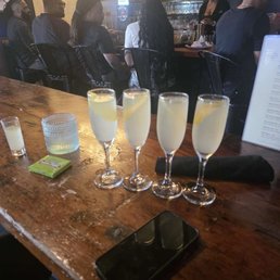 A white tea shot, a glass of water, and 4 French 75s!