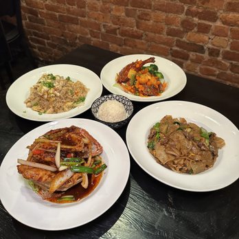 Cafe Chili - Dinner spread: pad see ew, red snapper, half duck, and crab fried rice - Thai Near Me - Brooklyn, New York