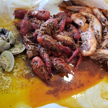 Crab In A Bag - Medium Cajun shrimp and crawfish with garlic steamed clams. And potatoes with corn.  Yummy! Meal was on point! - Seafood Near Me - Bakersfield, California