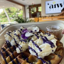Aiwi Waffles - Banana Mac Mochi Waffle with Ube Cream Cheese Topping and raw honey on the side