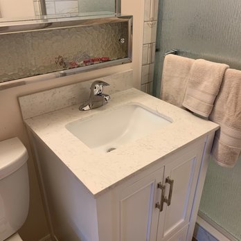 Reilex Construction - New vanity installed after repairing hot water leak, drywall behind, and new paint - Tiling Near Me