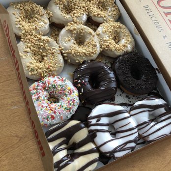 Duck Donuts - A box of one dozen assorted donuts. All great despite they forgot the caramel drizzle on one. - Donuts Near Me - Kitty Hawk, North Carolina