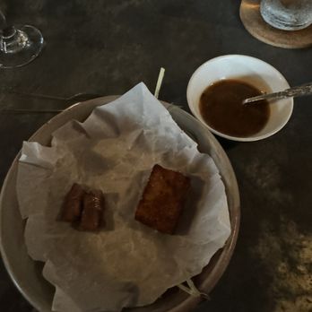 Saint Germain - Wagyu (left) and croquette (right) over hay.  May 2024 - Wine Bars Near Me - New Orleans, Louisiana