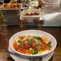 Shrimp and grits. Counter seating in front of the cooks. Shrimp and grits. Counter seating in front of the cooks.