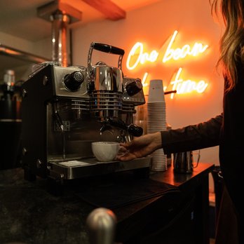 The Roastery - a woman preparing a cup of coffee - Coffee Roasteries Near Me - Stowe, Vermont The Roastery - a woman preparing a cup of coffee - Coffee Roasteries Near Me - Stowe, Vermont