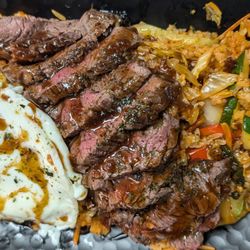 Savoury Eats Kitchen - Bulgogi Steak with Spicy Basil Fried Rice-Sliced Petit Filet Chateau over Hearty Vegetable Fried Rice. Drizzled with Bulgogi.