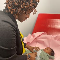 The Village of Healing Center - Provider Amber Black, FNP-BC, examines a precious baby during his appointment