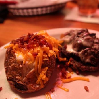 Texas Roadhouse - a loaded baked potato on a plate - Steakhouses Near Me - Washington, Pennsylvania