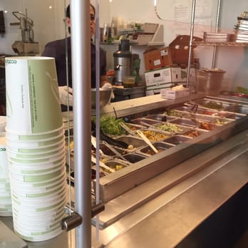 Naked Lunch - a woman standing in front of a buffet - Vegan Near Me - Rockville, Maryland Naked Lunch - a woman standing in front of a buffet - Vegan Near Me - Rockville, Maryland
