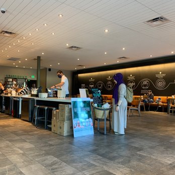 Starbucks - two people standing in a coffee shop - Coffee & Tea Near Me - Carmel, Indiana