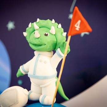 Sweeter Days Bake Shop - a green dragon holding a flag - Bakeries Near Me - Fort Lauderdale, Florida