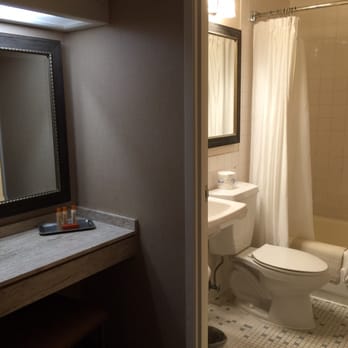 Bahia Resort Hotel - The horrible bathroom with public bathroom feel. ALL white and nothing else. Plumbing is also poor. - San Diego, CA