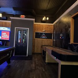 The Lamplight Tavern - Looking south - shuffle pucks and a pool table.