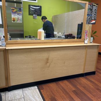 Tuna Poke 2 - a man standing at a counter in a restaurant - Poke Near Me - Olympia, Washington