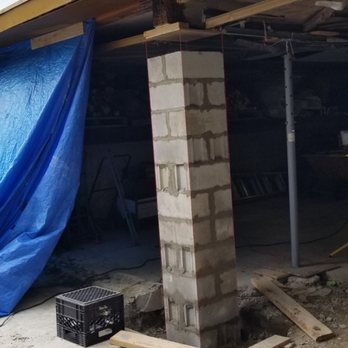 The Yorkshire Builder - an unfinished garage with a blue tarp - Carpenters Near Me The Yorkshire Builder - an unfinished garage with a blue tarp - Carpenters Near Me