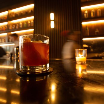 El Vecino - a drink in a glass on a bar - Cigar Bars Near Me - Miami, Florida El Vecino - a drink in a glass on a bar - Cigar Bars Near Me - Miami, Florida