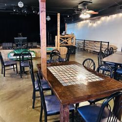 Arcadia Valley Coffee Company - Event Venue with Table and Chairs in Back - some have game themes
