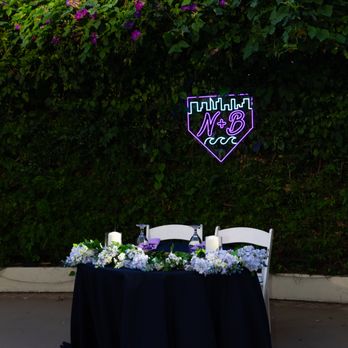 Bonaventure Brewing Company - a table with flowers and a neon sign - Breweries Near Me - Los Angeles, California