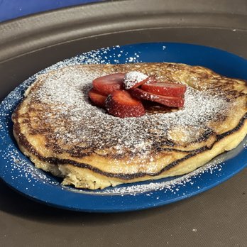 Rockwell Cafe - a plate of pancakes with strawberries and powdered sugar - American Near Me - Rockwell, North Carolina