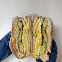 The Cornerstone Deli - Delicious egg and cheese sandwich with avocado on a fresh Kaiser roll.