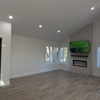 ARC Construction & Remodeling - Living room w/ new fireplace and tile flooring - General Contractors Near Me ARC Construction & Remodeling - Living room w/ new fireplace and tile flooring - General Contractors Near Me