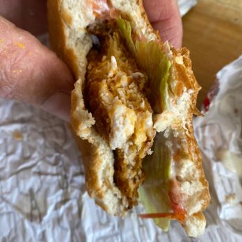Wendy's - a hand holding a half eaten sandwich - Burgers Near Me - East Greenbush, New York Wendy's - a hand holding a half eaten sandwich - Burgers Near Me - East Greenbush, New York