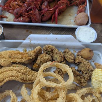 Rougeaux's - Our boiled crawfish at the top and my catfish filets, Oysters, and hand battered onion rings on the bottom. - Cajun/Creole Near Me - Nome, Texas