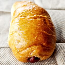 a hot dog wrapped in bread a hot dog wrapped in bread