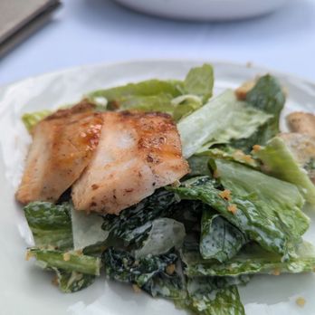 Latitudes - Sunset Key Cottages - Caesar salad with Grilled Honey Chipotle Chicken (on small plate from bigger bowl - behind) - Seafood Near Me - Key West, Florida Latitudes - Sunset Key Cottages - Caesar salad with Grilled Honey Chipotle Chicken (on small plate from bigger bowl - behind) - Seafood Near Me - Key West, Florida