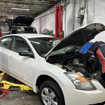 Angelo Auto Repair - Victor, a mechanic of 30 + years of experience working on a Nissan Altima 2007, replacing thermostat and flushing radiator. - Auto Repair Near Me - The Bronx, New York
