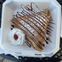 Aztlan Itza Neveria & Paleteria - Banana, strawberry, Nutella filled crepe with chocolate sauce, powdered sugar, and whipped cream on top.
