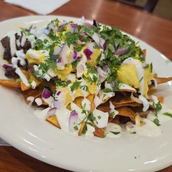 Broken Yolk Cafe - Carne asada green chilaquiles with scrambled eggs. - Breakfast & Brunch Near Me - La Quinta, California