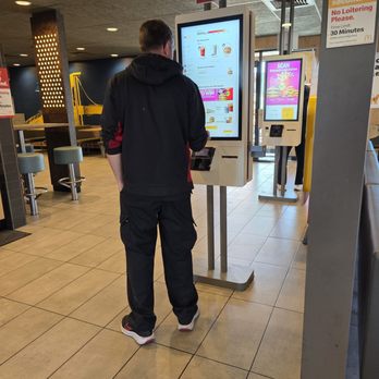 McDonald's - Order Kiosks - table tents for "eat in" orders are near pick-up counter. - Fast Food Near Me - Stroudsburg, Pennsylvania