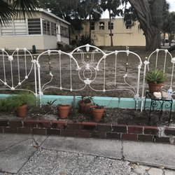 The 1910 Inn - The fencing all around the garden are old bed headboards panted white. Clever!!