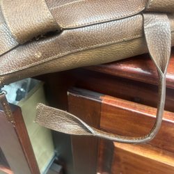 Taylor's Leatherwear & Fur - Notice how poor the stitching is for a load bearing item. The strap and handle pulled right through. I only had a laptop in this...