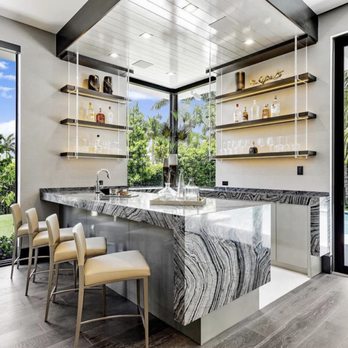 Absolute Marble And Granite - a modern kitchen with a marble island - Flooring Near Me - Pompano Beach, Florida