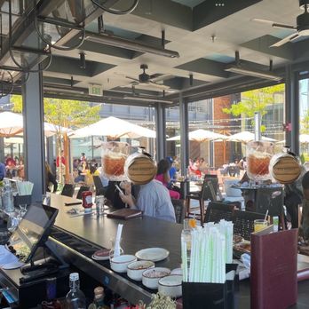 Rye Street Tavern - To the northwest, umbrellaed tables beyond the shaded open bar, with a creative skilled acoustic duo off to the right - Bars Near Me - Baltimore, Maryland Rye Street Tavern - To the northwest, umbrellaed tables beyond the shaded open bar, with a creative skilled acoustic duo off to the right - Bars Near Me - Baltimore, Maryland