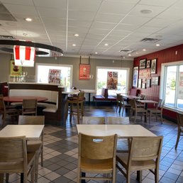 the inside of a restaurant with tables and chairs the inside of a restaurant with tables and chairs