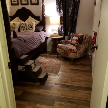 Long's Floors - a bedroom with a bed and a chair - Flooring Near Me - Issaquah, Washington Long's Floors - a bedroom with a bed and a chair - Flooring Near Me - Issaquah, Washington