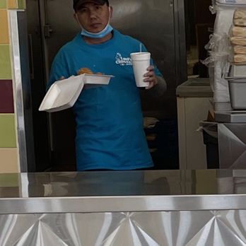 Luci's Chicken -N- Rice - Employee with chin guard on! Serving food! - American Near Me - Arlington, Texas Luci's Chicken -N- Rice - Employee with chin guard on! Serving food! - American Near Me - Arlington, Texas