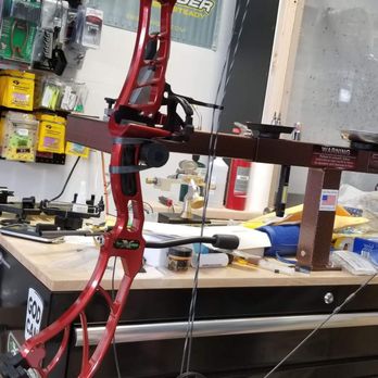 Obsession Archery - The bow is placed on a "draw board" to measure or set the draw length, one of the most critical settings.  3 of 3. - Archery Near Me