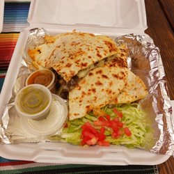 Nacho’s Tacos - Steak and cheese quesadilla with lettuce, chopped tomato and sour cream.