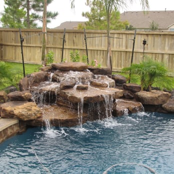 Smarter Sprinklers - a waterfall in a backyard pool - Landscaping Near Me Smarter Sprinklers - a waterfall in a backyard pool - Landscaping Near Me